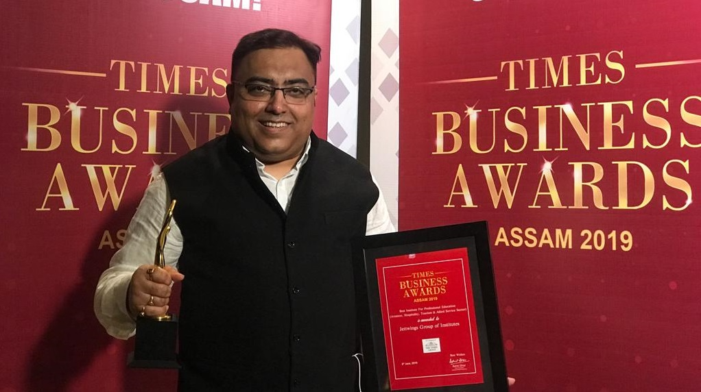 Man holding Times Business Award 2019